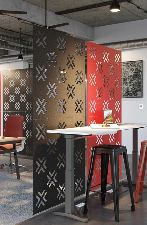 A modern office featuring red and black furniture, complemented by stylish acoustic panels on the walls.