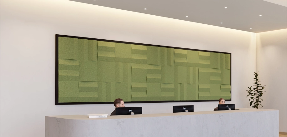 A reception desk set against a green wall with acoustic panels for improved acoustics.