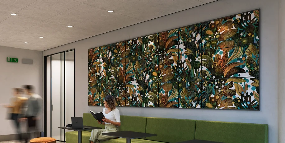 A reception desk set against a green wall with acoustic panels for improved acoustics.